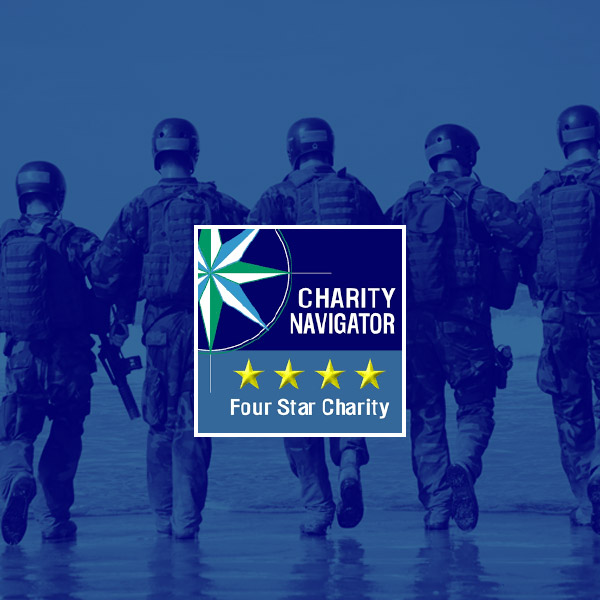 Navy personnel walking with a Charity Navigator "Four Star Charity" rating displayed.