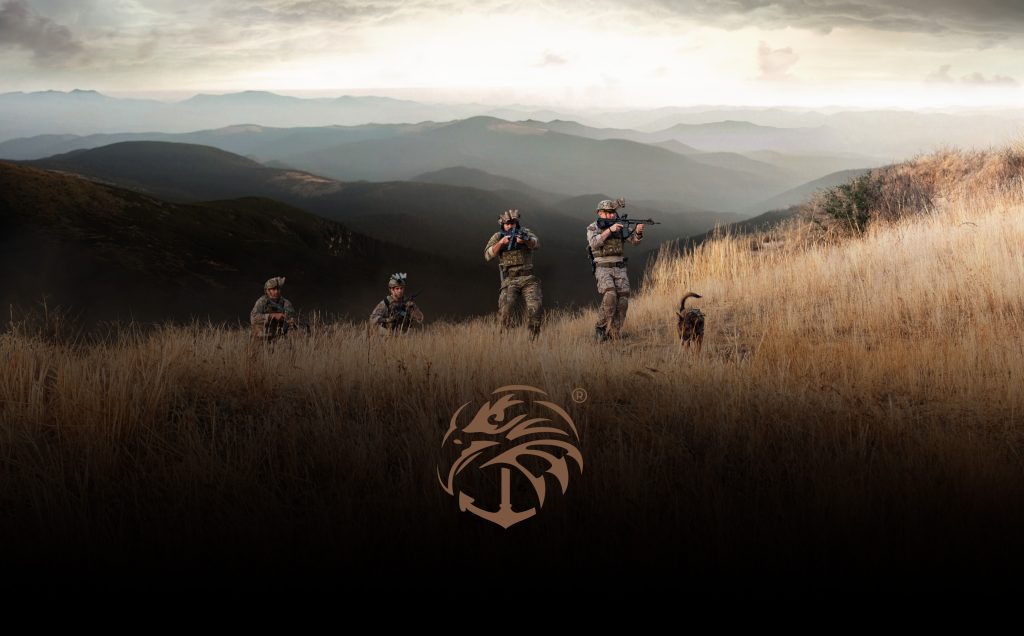 Soldiers in tactical gear are in a grassy, mountainous landscape with a dog. Navy seal wallpaper.