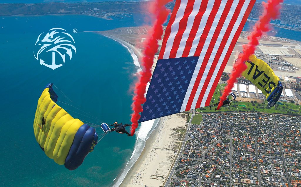Parachutists descend with an American flag over a coastal area, leaving red smoke trails. Navy seal wallpaper.