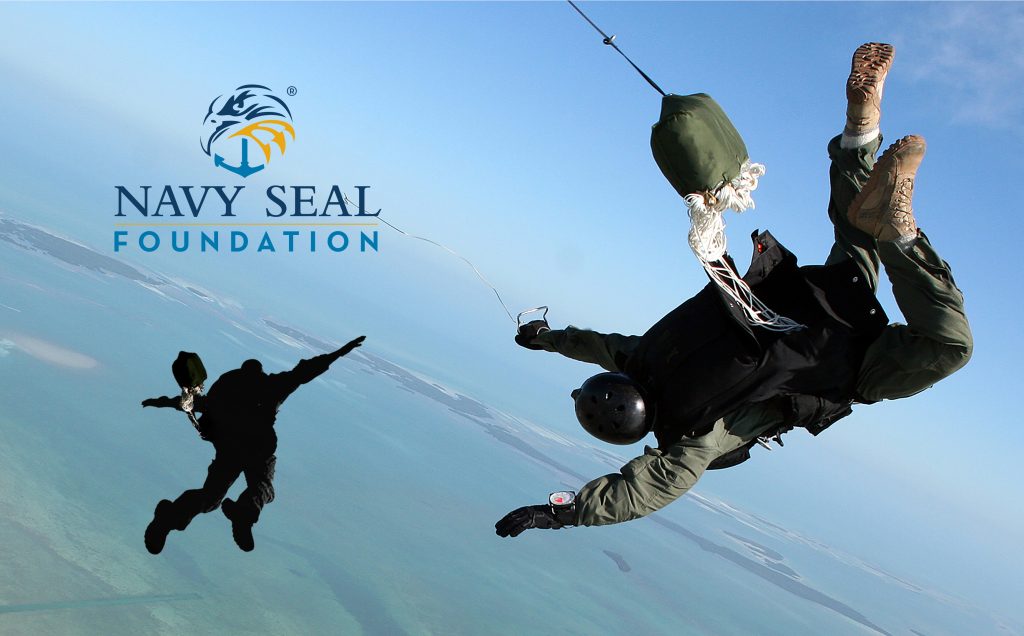 A person skydiving with a Navy SEAL Foundation logo, suited in military gear. Navy seal wallpaper is appropriate.